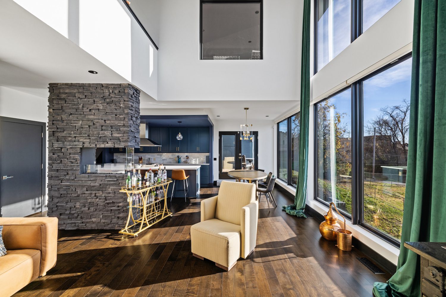 Stylish Living Room With A Stone Fireplace And Big Windows